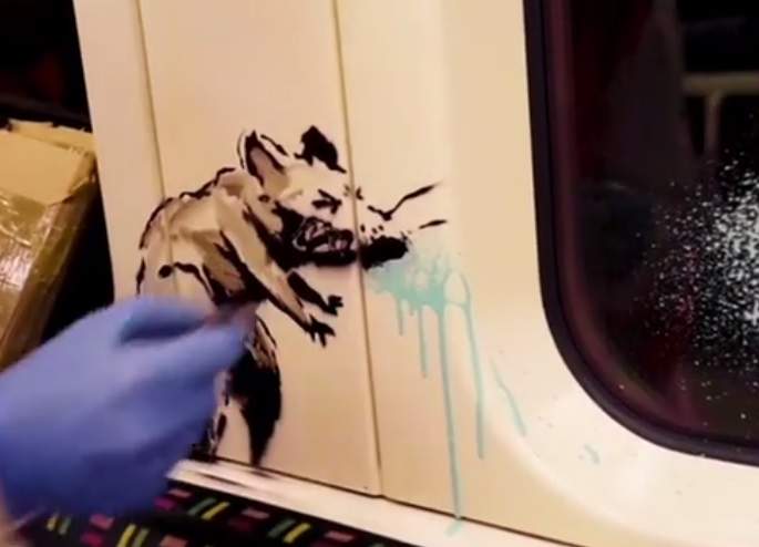 This undated photo issued on Tuesday July 14, 2020 by JBPR, shows Banksy’s latest work sprayed on the inside of a London Underground tube carriage.