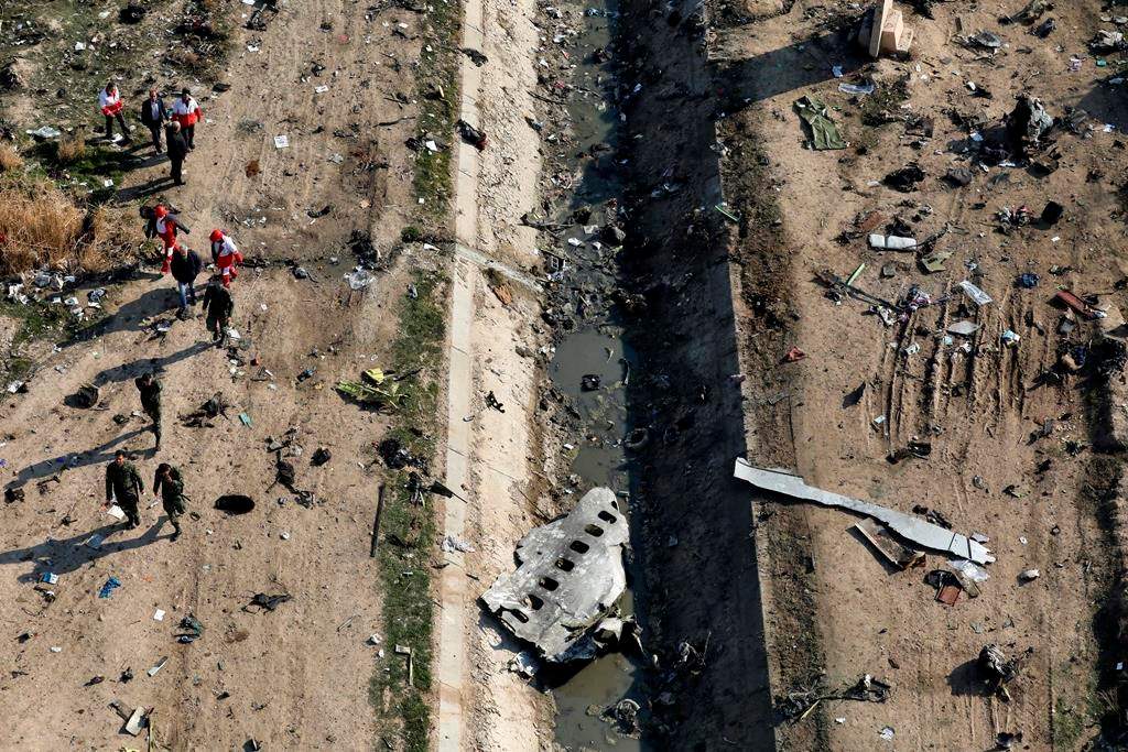 FILE - In this Jan. 8, 2020 file photo, rescue workers search the scene where a Ukrainian plane crashed in Shahedshahr, southwest of Tehran, Iran.