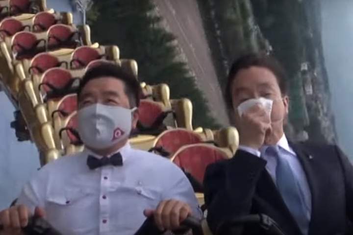 Two executives ride the Fujiyama rollercoaster in silence at Fuji-Q Highland theme park in Japan in this image captured from video.