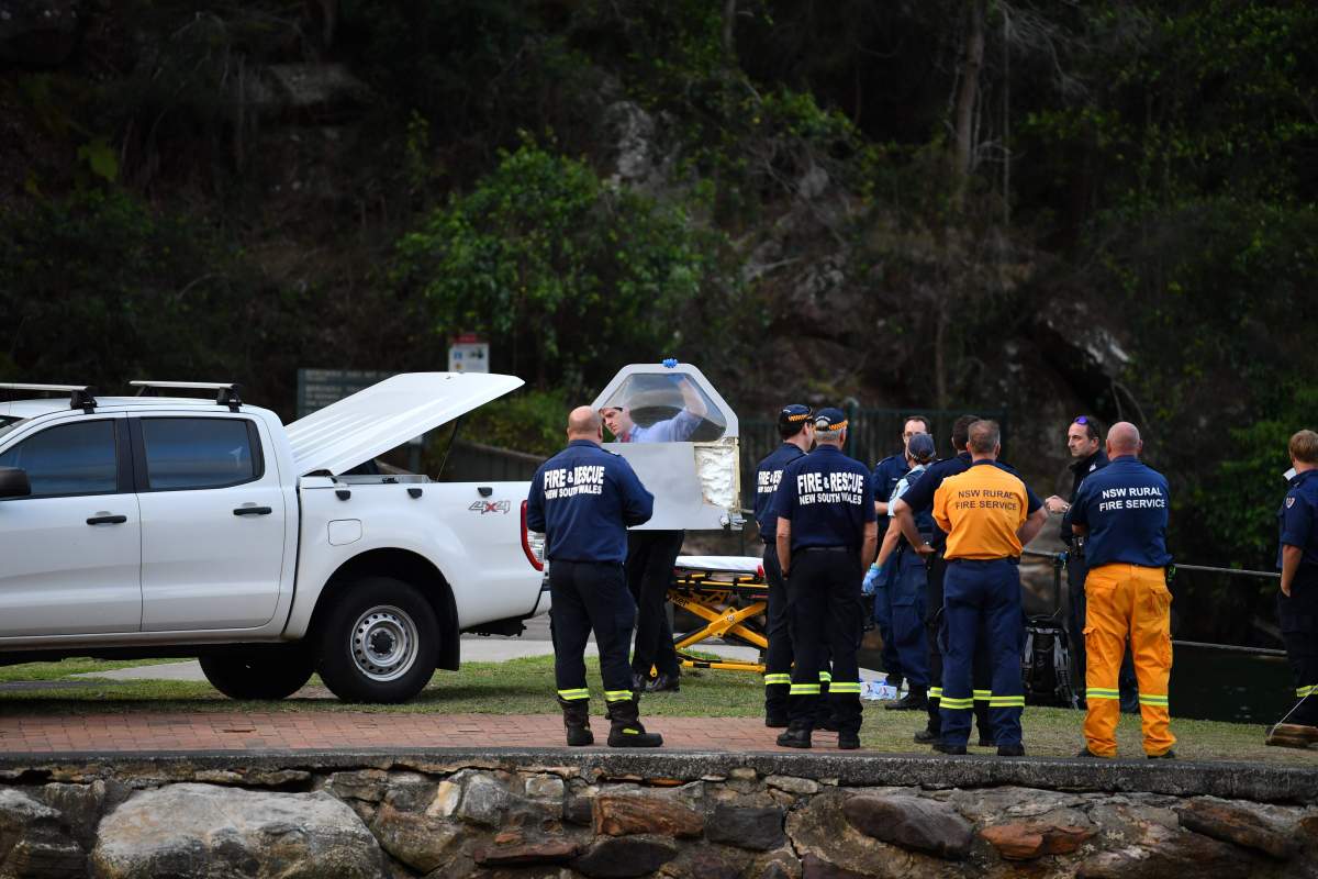 An officer carries a piece of debris recovered from a seaplane that crashed into the Hawkesbury River at Apple Tree Bay, Ku-ring-gai Chase National Park in NSW, Sydney, Australia, 31 December 2017.   