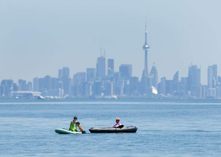 People enjoy activities on Lake Ontario overlooking the City of Toronto skyline during the COVID-19 pandemic at Jack Darling Park in Mississauga on Wednesday, June 17, 2020. 
