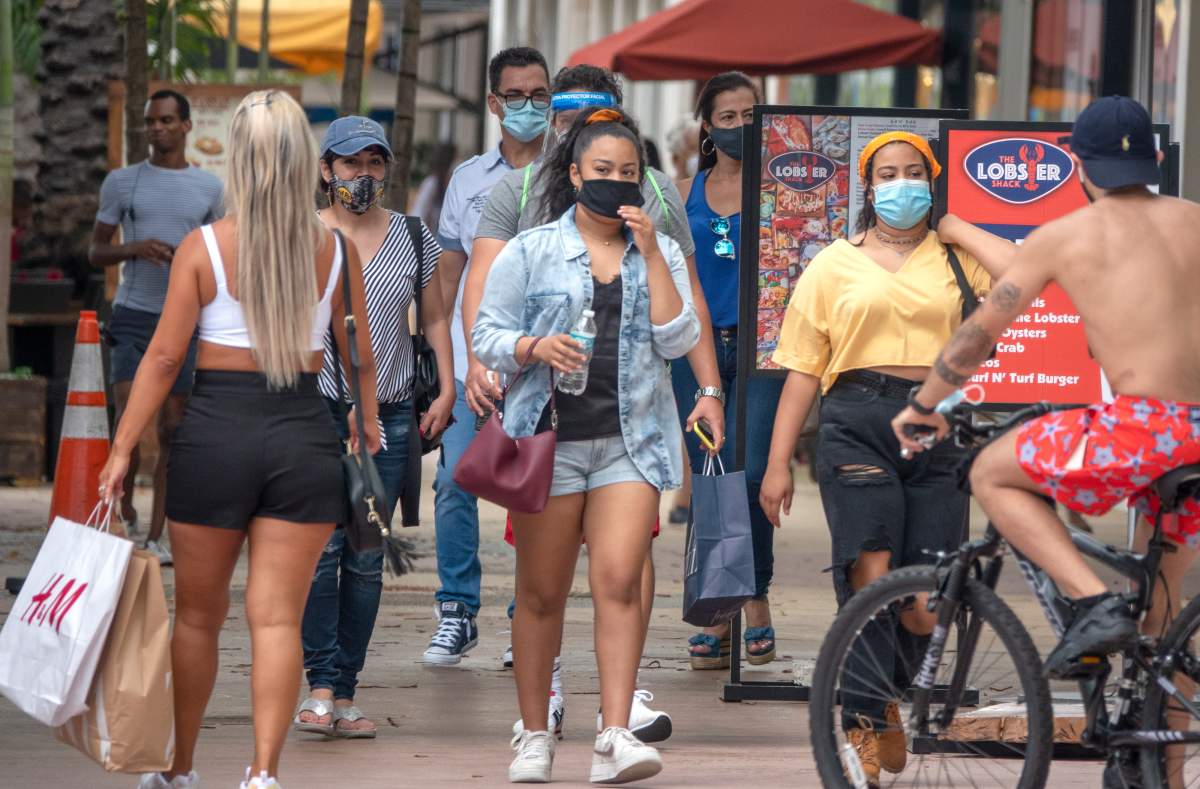 People walk through Lincoln Road in Miami Beach, Florida, USA, 12 July 2020. Florida reports 15,300 new Coronavirus cases, a record for one day anywhere in the U.S. EPA/CRISTOBAL HERRERA