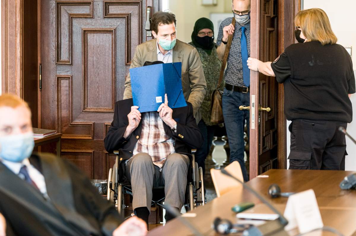 Defendant Bruno Dey is pushed into the courtroom on a wheelchair for the continuation of the trial against him in Hamburg, Germany, 14 July 2020.   