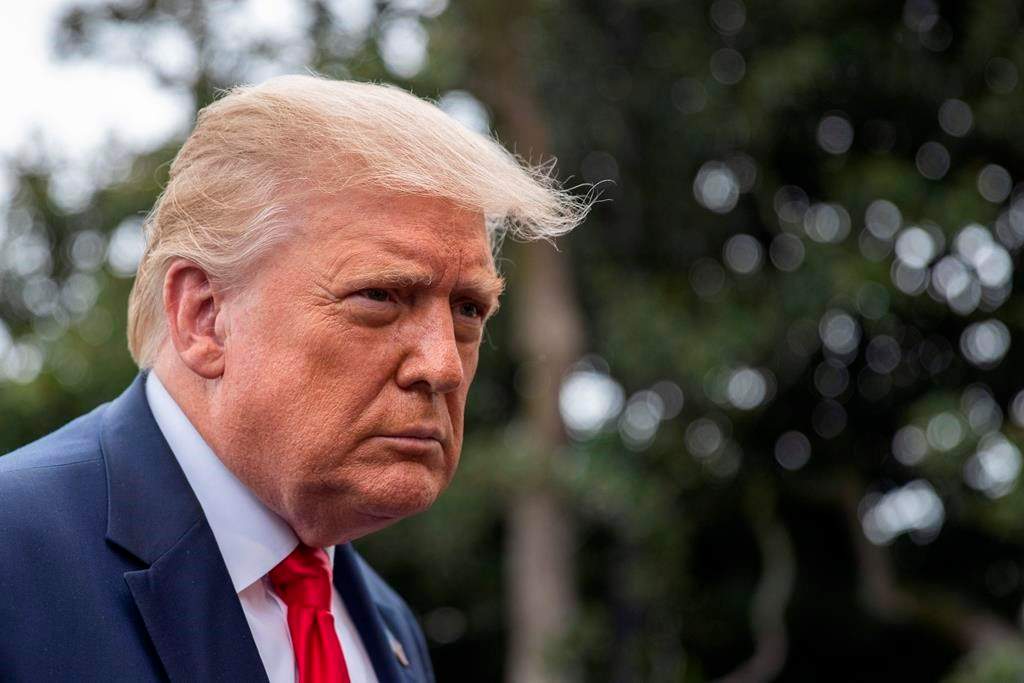President Donald Trump speaks with reporters as he walks to Marine One on the South Lawn of the White House, Friday, July 31, 2020, in Washington. Trump is en route to Florida.