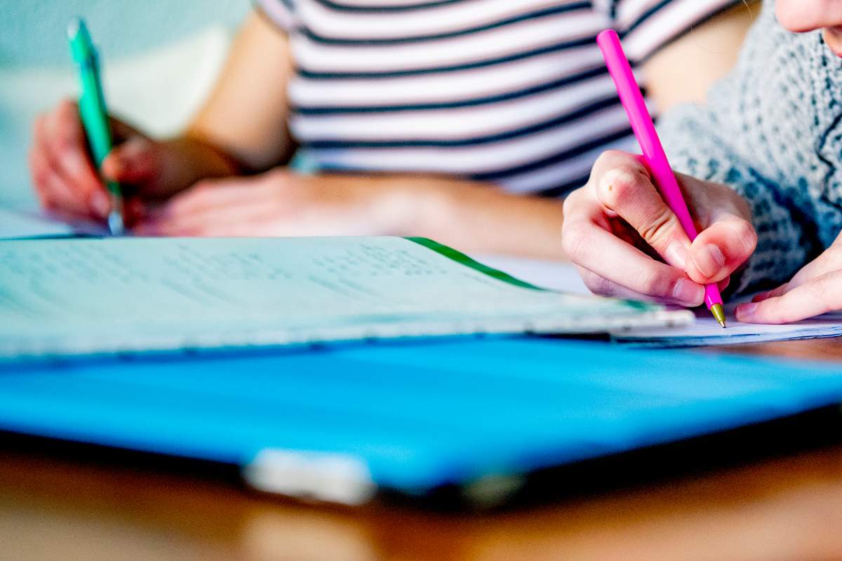 Two female students study and do homework at their home.
