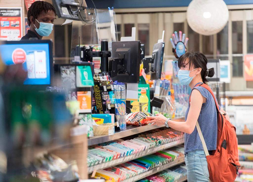 A woman wears a face mask at a convenience store in Montreal.