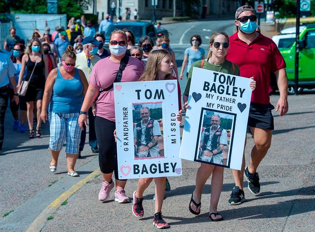 Family and friends of victims of the deadly Nova Scotia mass shootings display their appreciation after an inquiry was announced, in Halifax on Wednesday, July 29, 2020. The federal and provincial governments will launch an inquiry instead of a review that had no power to compel testimony or deliver binding recommendations. THE CANADIAN PRESS/Andrew Vaughan.