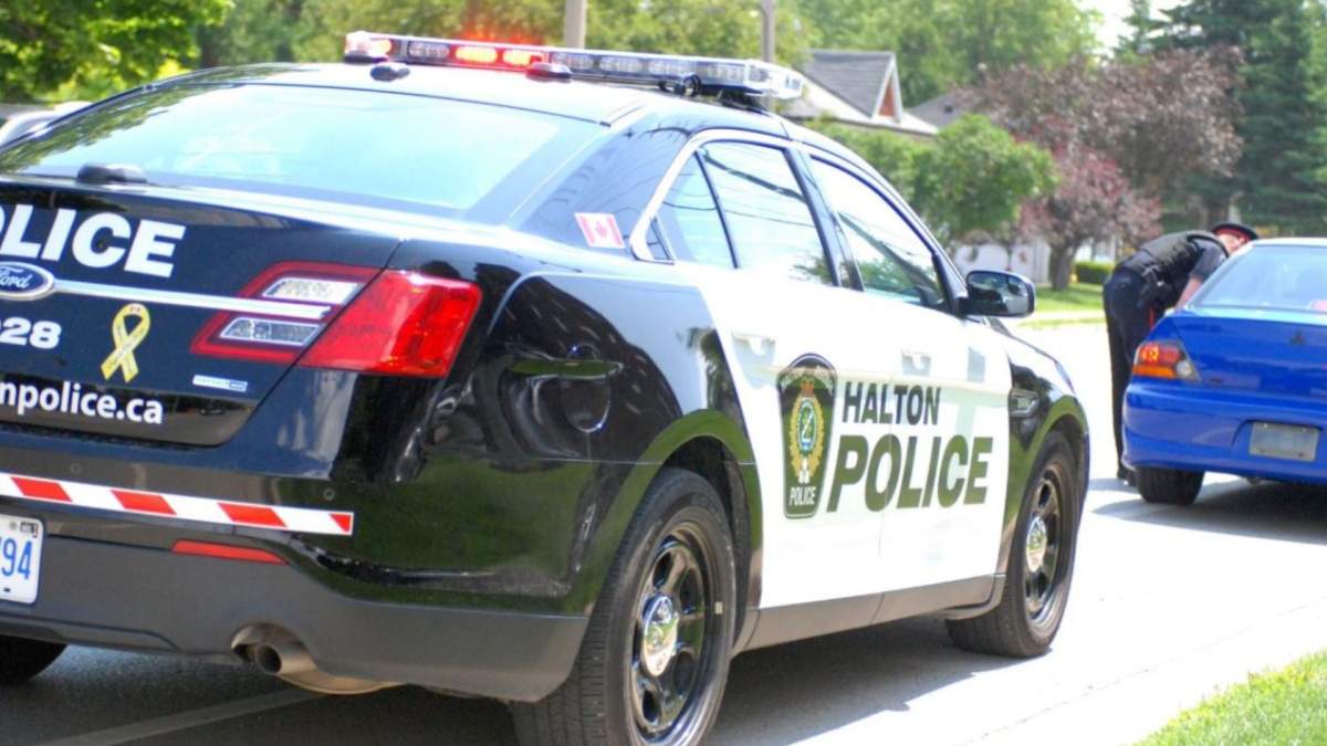 Halton Regional Police say a quarantine compliance officer in facing sexual assault and extortion charges after an alleged incident in Oakville.