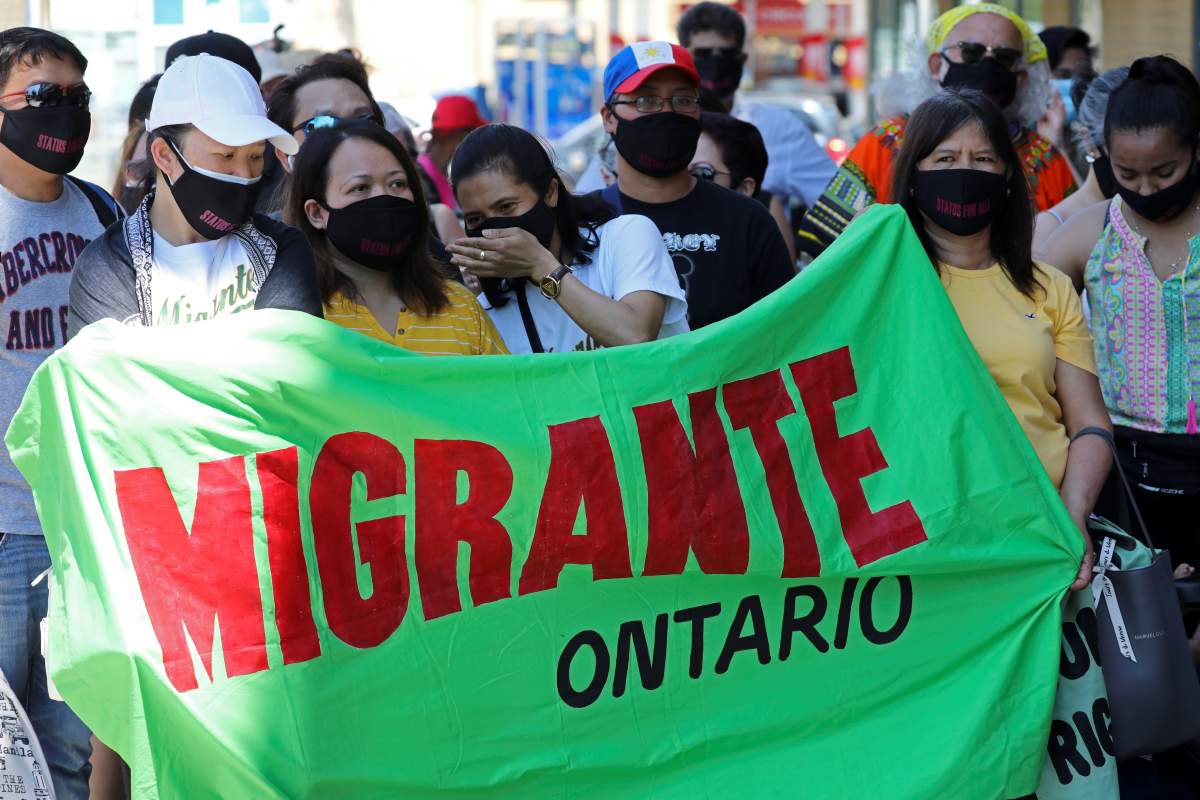 Migrants, refugees, undocumented workers and their supporters rally outside the office Canada's Immigration Minister Marco Mendicino in Toronto, Ontario, Canada July 4, 2020.  REUTERS/Chris Helgren.