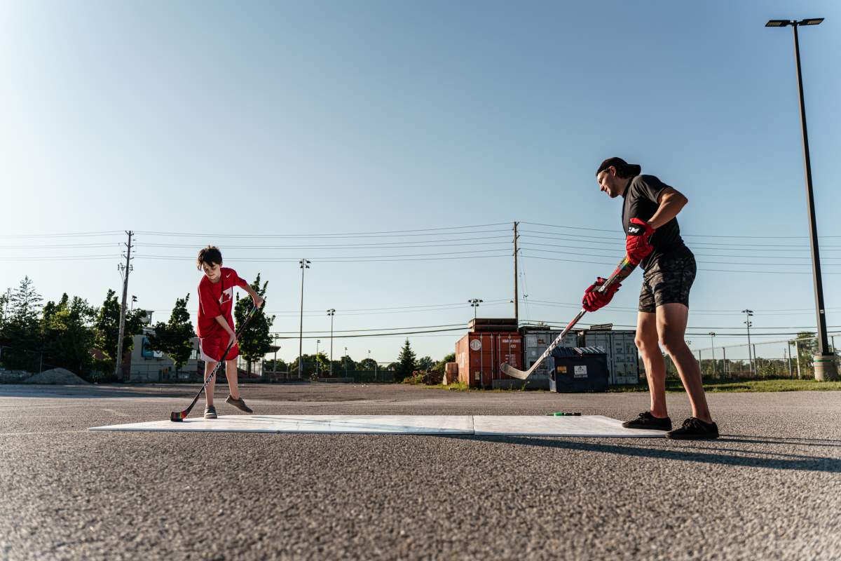 10-year-old Cullen Kotarba (left) and professional hockey player Kurtis Gabriel (right)