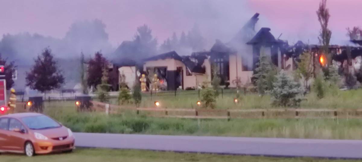 Smoke billows from a home in Parkland County near Edmonton after an apparent lightning strike.