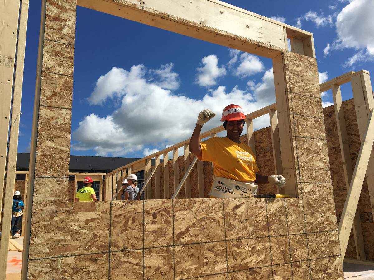 Teruework in the window of her future home thanks to Habitat for Humanity. 