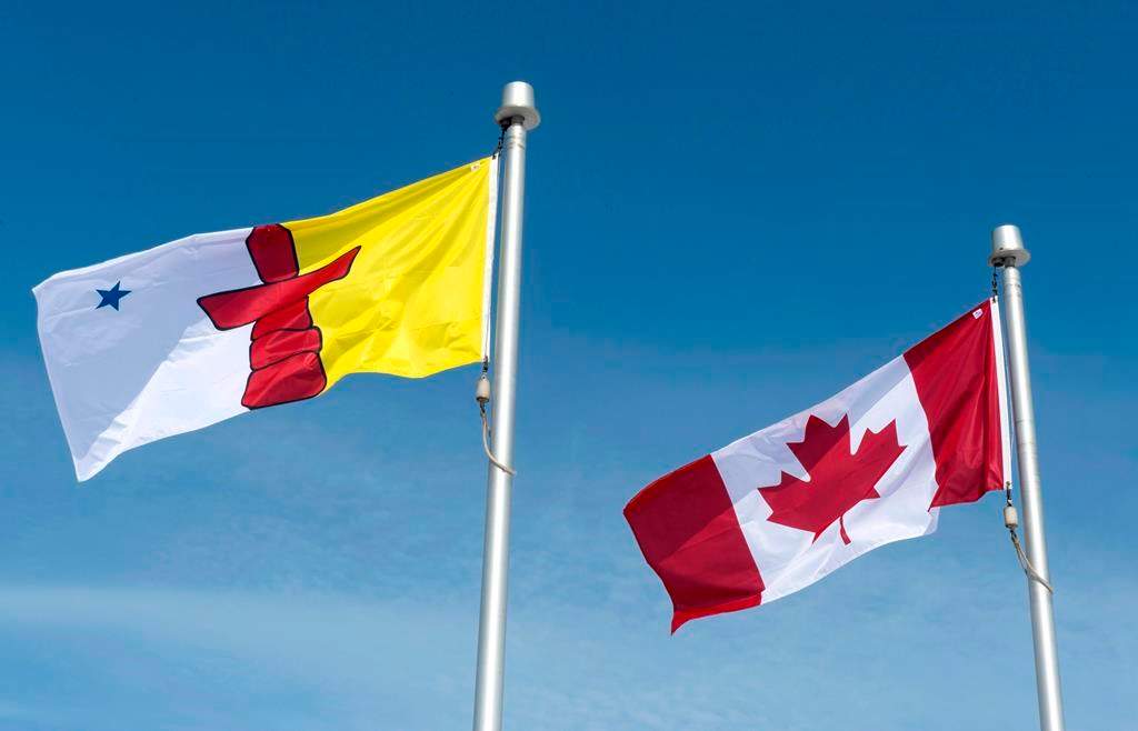 The Nunavut flag and the Canadian flag are seen Saturday, April 25, 2015 in Iqaluit, Nunavut.