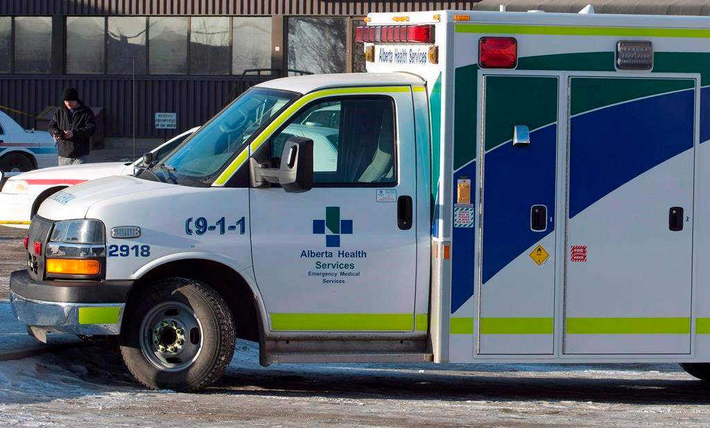 An ambulance waits at the scene as police investigate at a warehouse in Edmonton, on Friday, February 28, 2014. A hospital in west Edmonton has new restrictions in place as the number of COVID-19 cases continues to grow. THE CANADIAN PRESS/Jason Franson.
