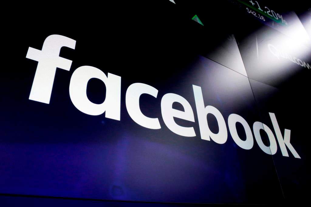A Facebook logo is shown on screens at the Nasdaq MarketSite in New York's Times Square on March 29, 2018. A First Nations elder who led mediation circles after a social media post called for violence against Indigenous people says she is disappointed one of three women arrested has not faced consequences. "We do not accept racism," said Irene Young. THE CANADIAN PRESS/AP, Richard Drew.