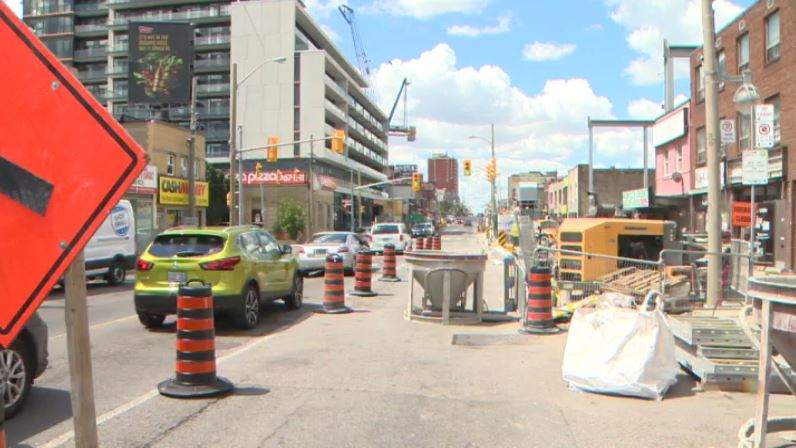 Eglinton Crosstown LRT construction scaffolding and equipment obstructing storefronts at Eglinton and Oakwood avenues. 