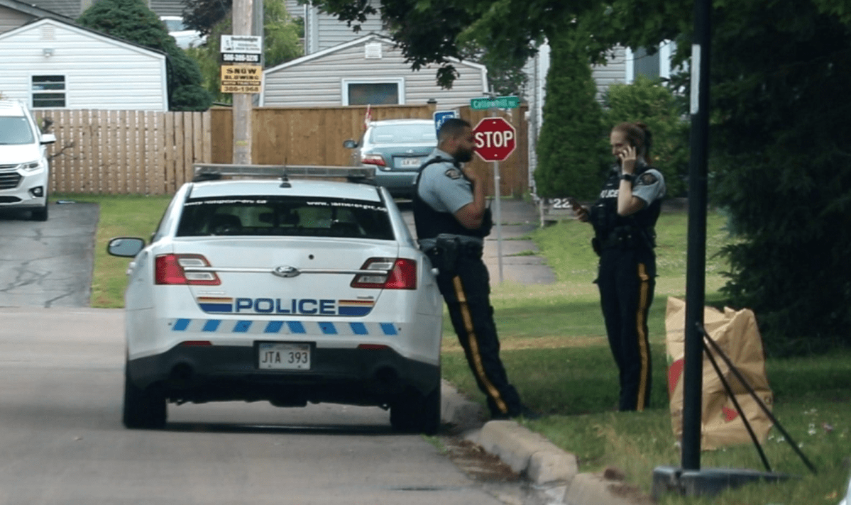 Codiac RCMP officers stand outside a crime scene in Moncton, New Brunswick, in this file photo.