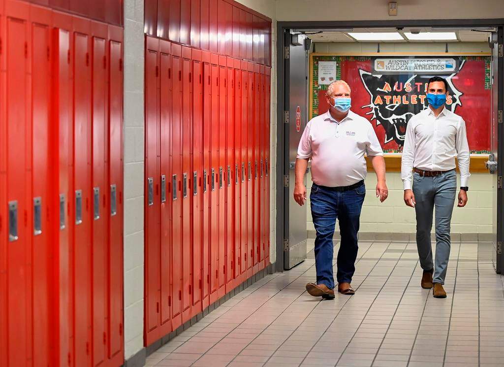 Ontario Premier Doug Ford, left, and Education Minister Stephen Lecce walk the hallway before making an announcement regarding the governments plan for a safe reopening of schools in the fall due to the COVID-19 pandemic at Father Leo J Austin Catholic Secondary School in Whitby, Ont., on Thursday, July 30, 2020. Denette.