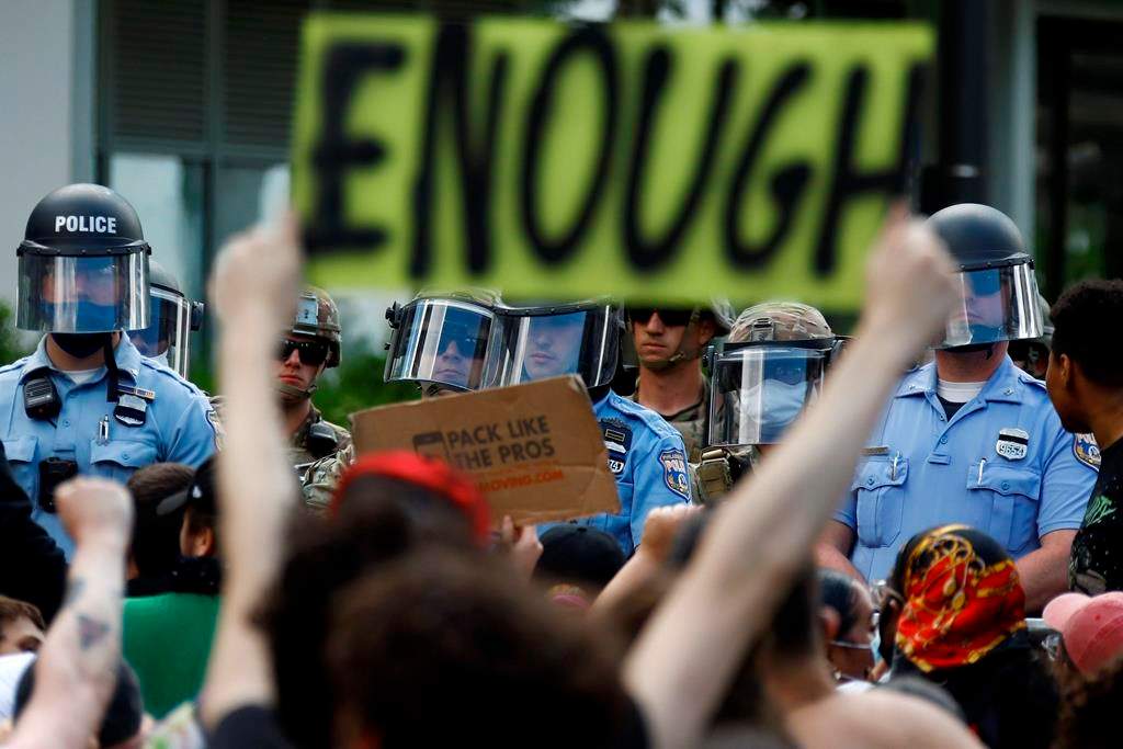 FILE - In this June 1, 2020, file photo, protesters rally as Philadelphia Police officers and Pennsylvania National Guard soldiers look on in Philadelphia, over the death of George Floyd, a black man who was in police custody in Minneapolis.