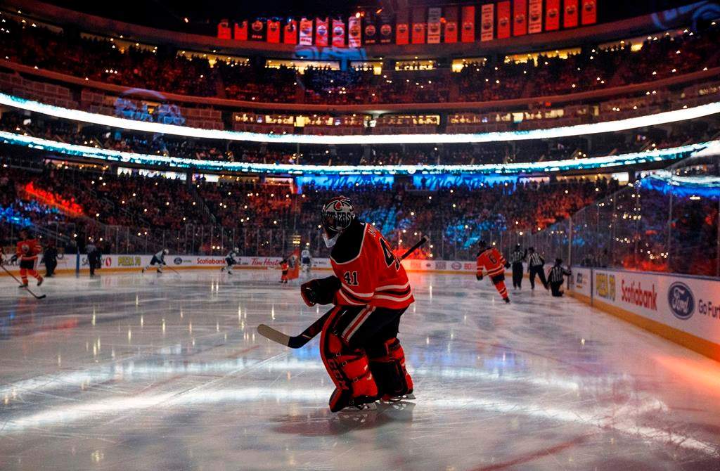 FILE - In this Feb. 20, 2020, file photo, Edmonton Oilers goalie Mike Smith warms up for the team's NHL hockey game against the Winnipeg Jets in Edmonton, Alberta.