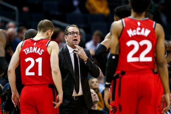 In this Jan. 8, 2020, file photo, Toronto Raptors coach Nick Nurse, center, gathers his team during a timeout in the first half of an NBA basketball game against the Charlotte Hornets in Charlotte, N.C.