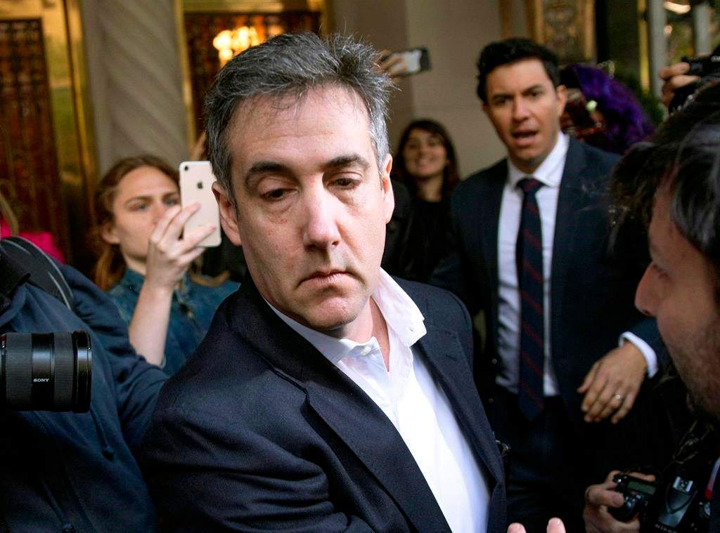 FILE - In this May 6, 2019, file photo, Michael Cohen, former attorney to President Donald Trump, leaves his apartment building before beginning his prison term in New York.l Cohen, was returned to federal prison, weeks after his early release to serve the remainder of his sentence at home because of the coronavirus pandemic, the federal Bureau of Prisons said Thursday, July 9, 2020.