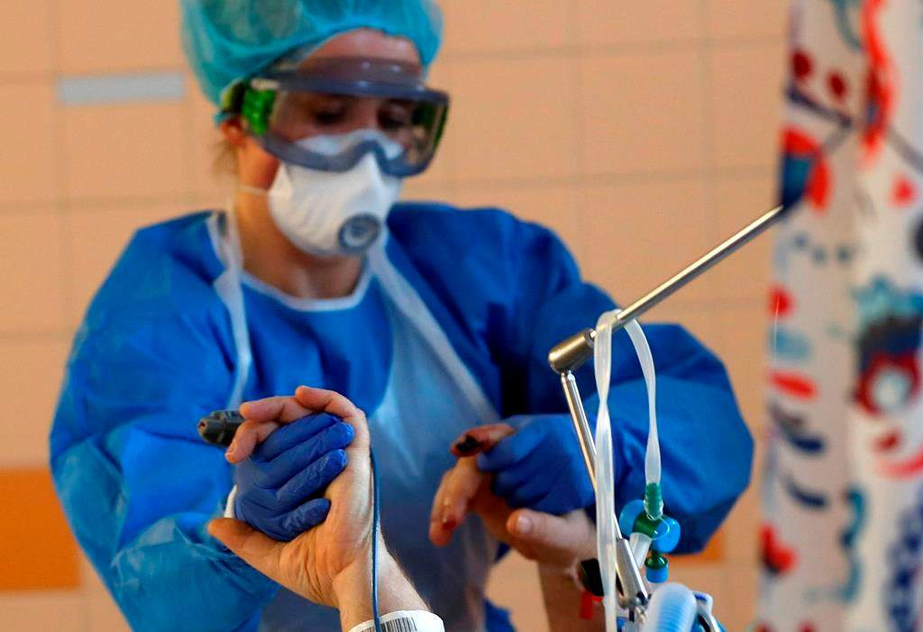A health-care worker attends to a COVID-19 patient in an intensive care unit (ICU) at the General University Hospital in Prague, Czech Republic, Tuesday, April 7, 2020. The Centre of Excellence on Post-Traumatic Stress Disorder says health-care workers on the front lines of the COVID-19 pandemic are susceptible to severe stress that could cause long-term psychological damage. THE CANADIAN PRESS/AP/Petr David Josek.