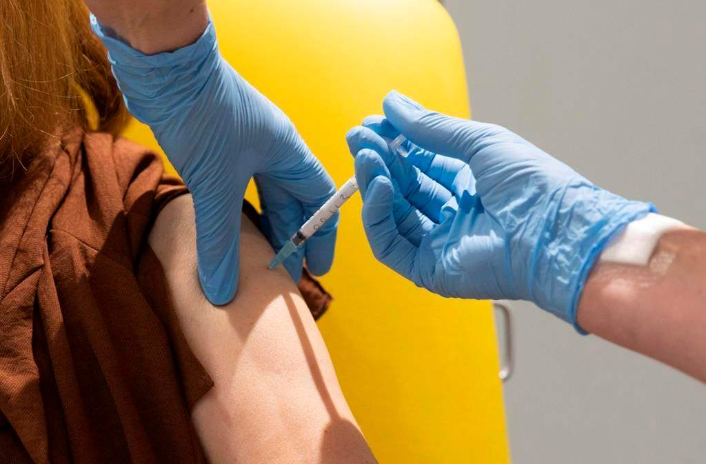 In this handout photo released by the University of Oxford a volunteer participates in the vaccine trial in Oxford, England on July 7, 2020.