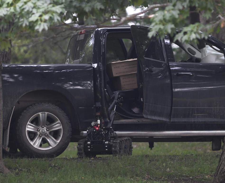 A police robot approaches a pickup truck inside the grounds of Rideau Hall in Ottawa on Thursday, July 2, 2020. The man accused of ramming through a gate at Rideau Hall while heavily armed is staying in an Ontario jail for another three weeks. 