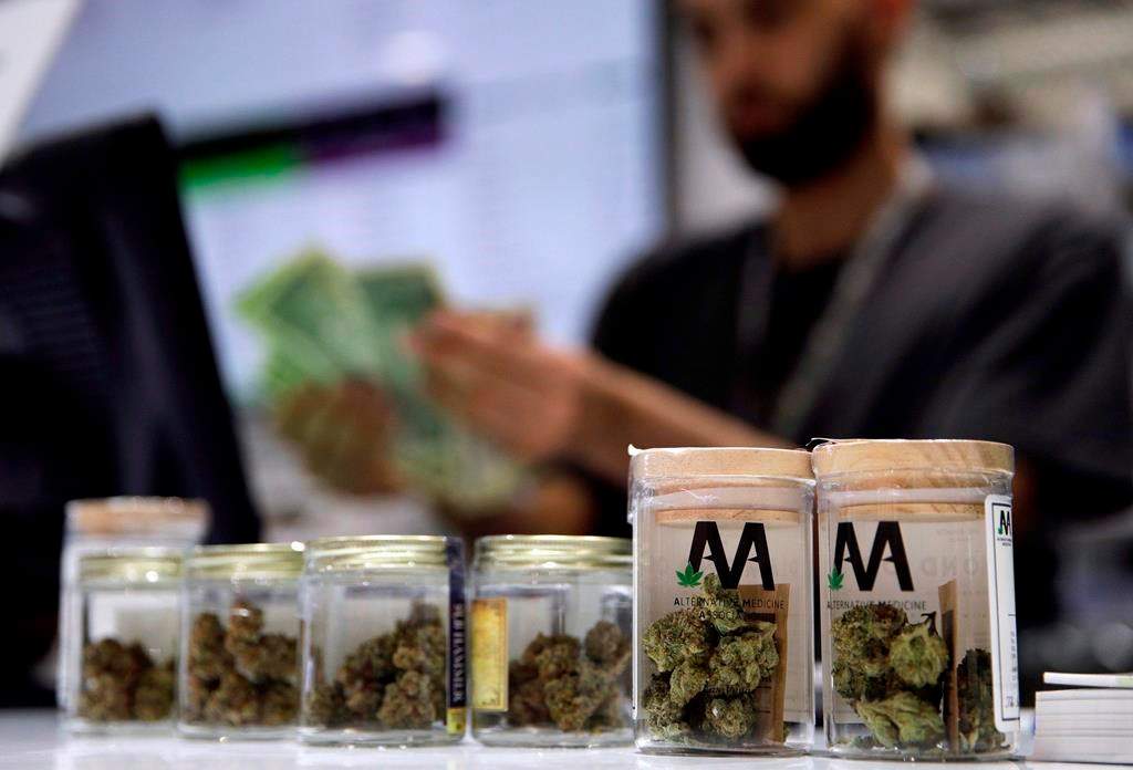 In this July 1, 2017, file photo, a cashier rings up a marijuana sale at a cannabis dispensary in Las Vegas. Ontario's private cannabis stores will have to give up offering delivery and curbside pickup next week — and they're not happy about it. THE CANADIAN PRESS/AP/John Locher.