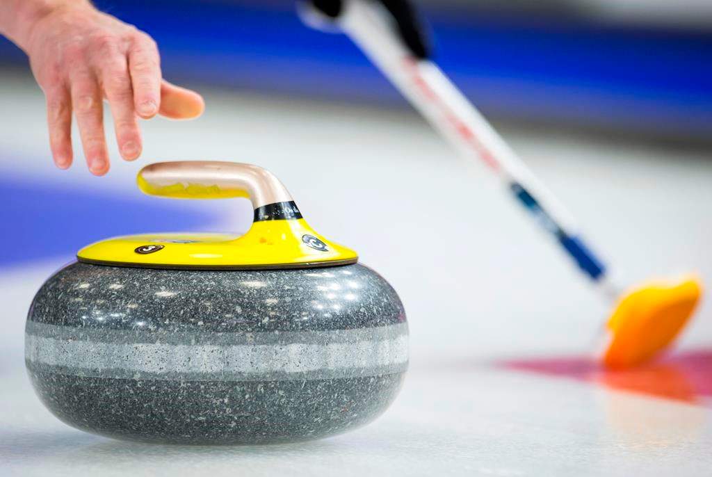 A curler releases a rock during play at the 2019 Brier.
