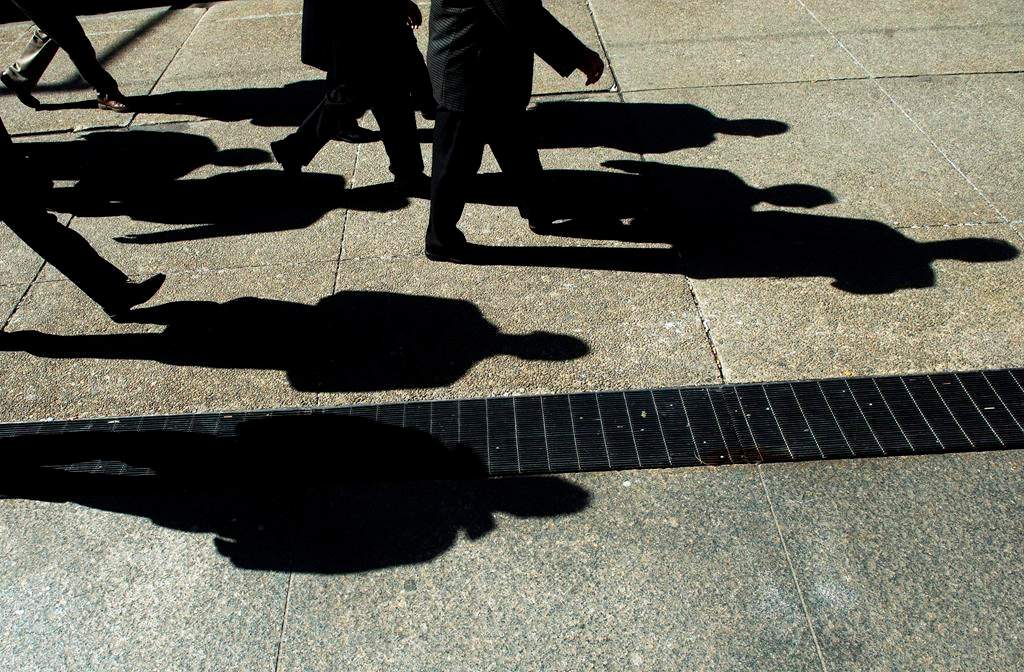 People walk in Toronto's financial district on Monday, Feb. 27, 2012.