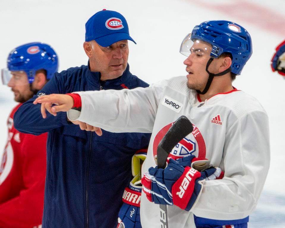 Montreal Canadiens head coach Claude Julien, goes over a drill with forward Nick Suzuki during practice Friday, July 17, 2020 in Brossard, Que.