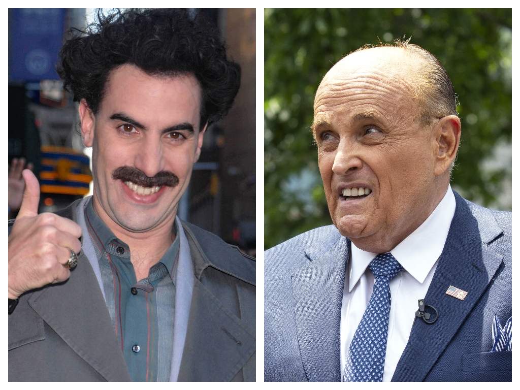 (L-R) British comedian Sacha Baron Cohen dressed as the fictional character Borat and former New York City mayor Rudy Giuliani.