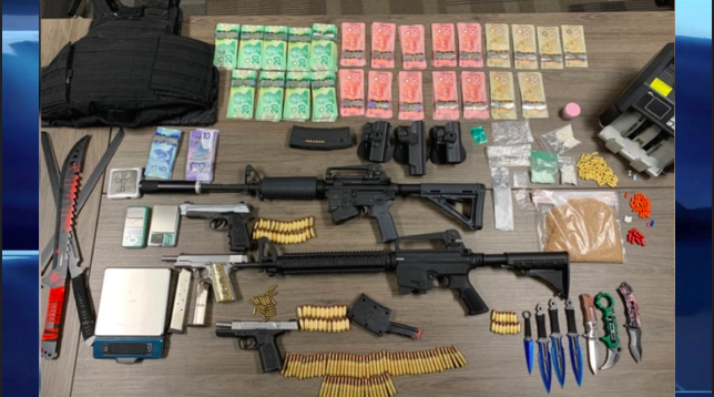 Police say they seized $35,500 in drugs, $24,500 in cash, as well as guns, scales, a bullet proof vest and several knives.