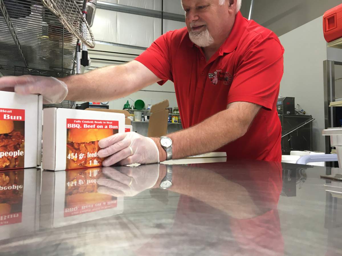 Ernie Kleinsasser packaging up BBQ pulled pork and beef.