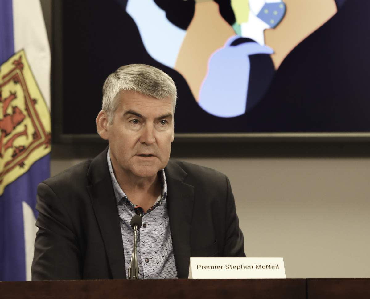 Nova Scotia Premier Stephen McNeil addresses reporters on July 31, 2020, the first day masks became mandatory in public indoor spaces in the province. He was wearing a mask before he sat down at his desk.