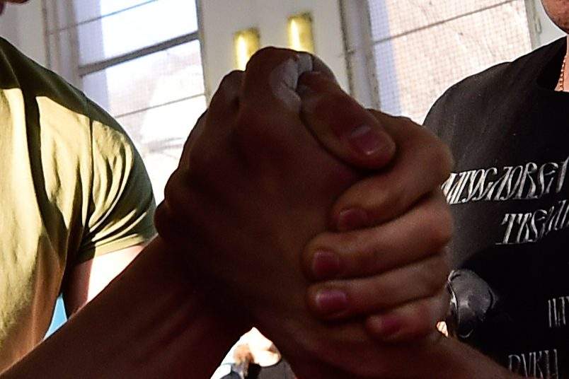 Two individuals clasp hands in an arm wrestling match in this file photo.