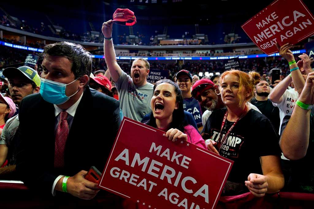 FILE - In this June 20, 2020, file photo President Donald Trump supporters cheer as they attend a campaign rally at the BOK Center in Tulsa, Okla. (AP Photo/Evan Vucci, File).