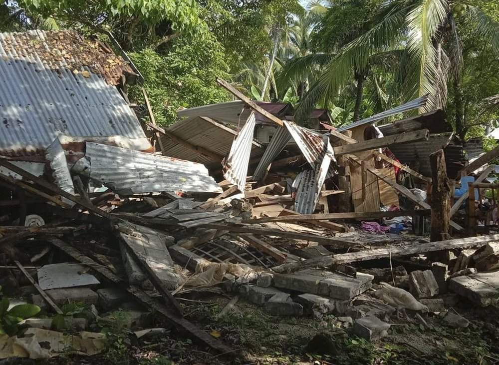 In this photo provided by the Philippine Red Cross, a toppled house is seen after a quake struck in Cataingan, Masbate province, central Philippines on Tuesday Aug. 18, 2020. A powerful and shallow earthquake struck a central Philippine region Tuesday, prompting people to dash out of homes and offices but there were no immediate reports of injuries or major damage. 