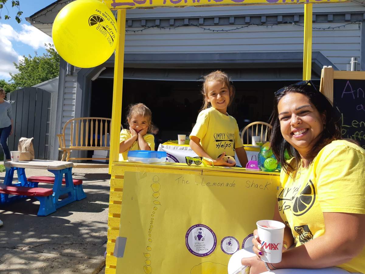 Bella and Lily Desrosiers along with the organizer of Simply Supper’s Lemonade Stand Day.