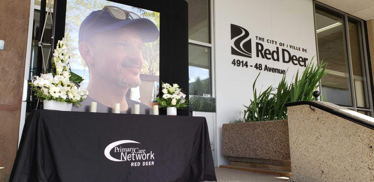 A vigil for Dr. Walter Reynolds, a family physician killed in an attack on Aug. 10, outside city hall in Red Deer.