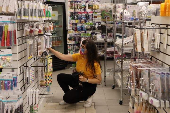 Sparkles employee Maha Mogab organizes the shop’s icing and cake decorating supplies on Aug. 4, 2020. Pamela Pagano/ Global News