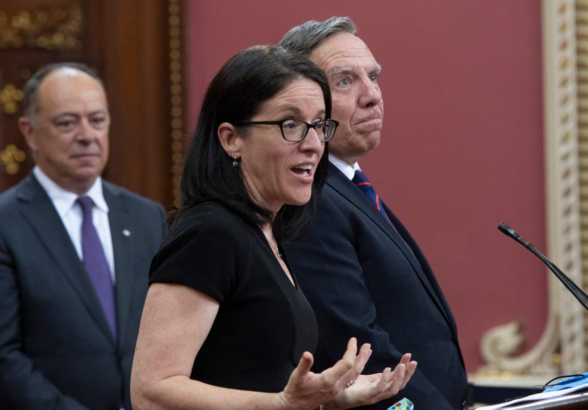 Treasury Board President Sonia Lebel responds to reporters questions after Quebec Premier Francois Legault, right, announced a cabinet shuffle, Monday, June 22, 2020 at the legislature in Quebec City. 