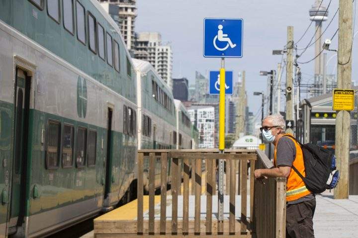 A man wearing a face mask is seen on the platform of a GO train station in Toronto on July 21, 2020. 
