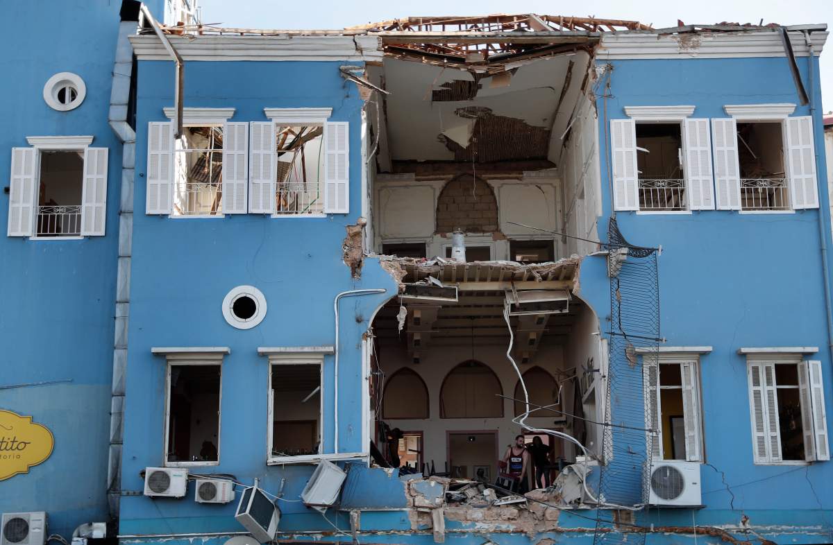 Workers remove debris from a damaged restaurant a day after an explosion hit the seaport of Beirut, Lebanon, Wednesday, Aug. 5, 2020. AP Photo/Hussein Malla
