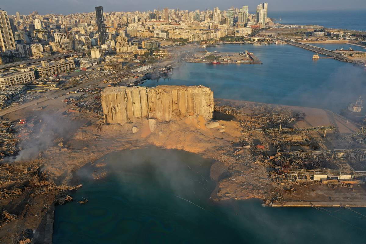 Smoke rises from the scene of an explosion that hit the seaport of Beirut, Lebanon, Wednesday, Aug. 5, 2020. AP Photo/Hussein Malla