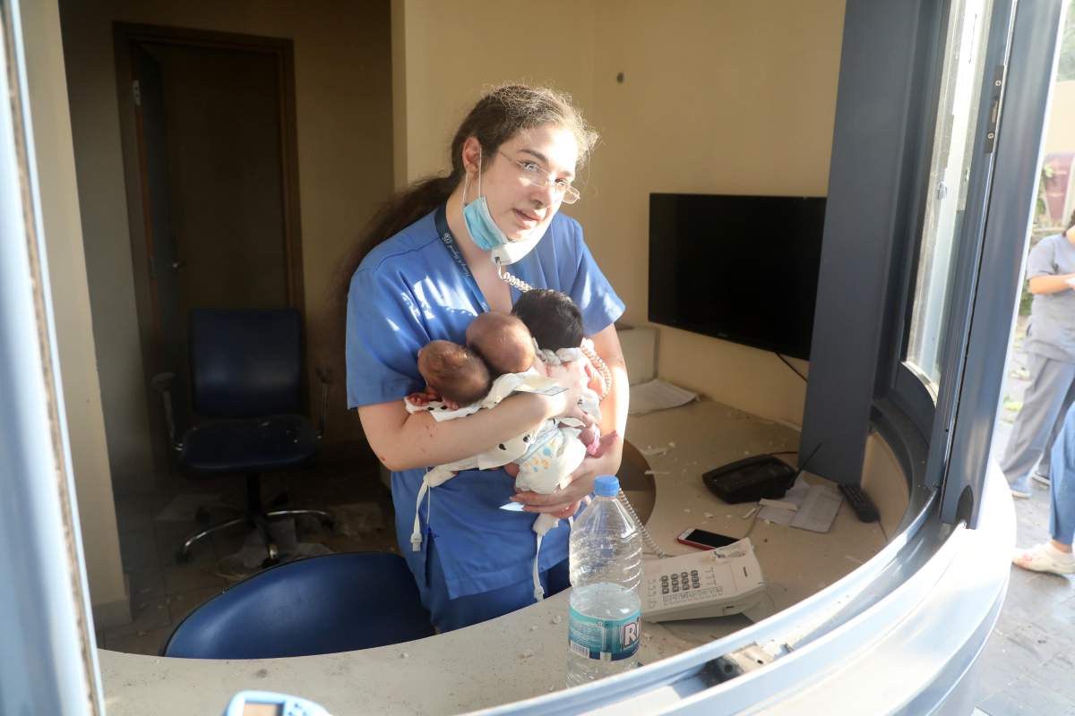 A nurse takes care of three babies in a damaged hospital after the explosion in Beirut, Lebanon, Aug. 4, 2020. Xinhua via ZUMA Press/via CP