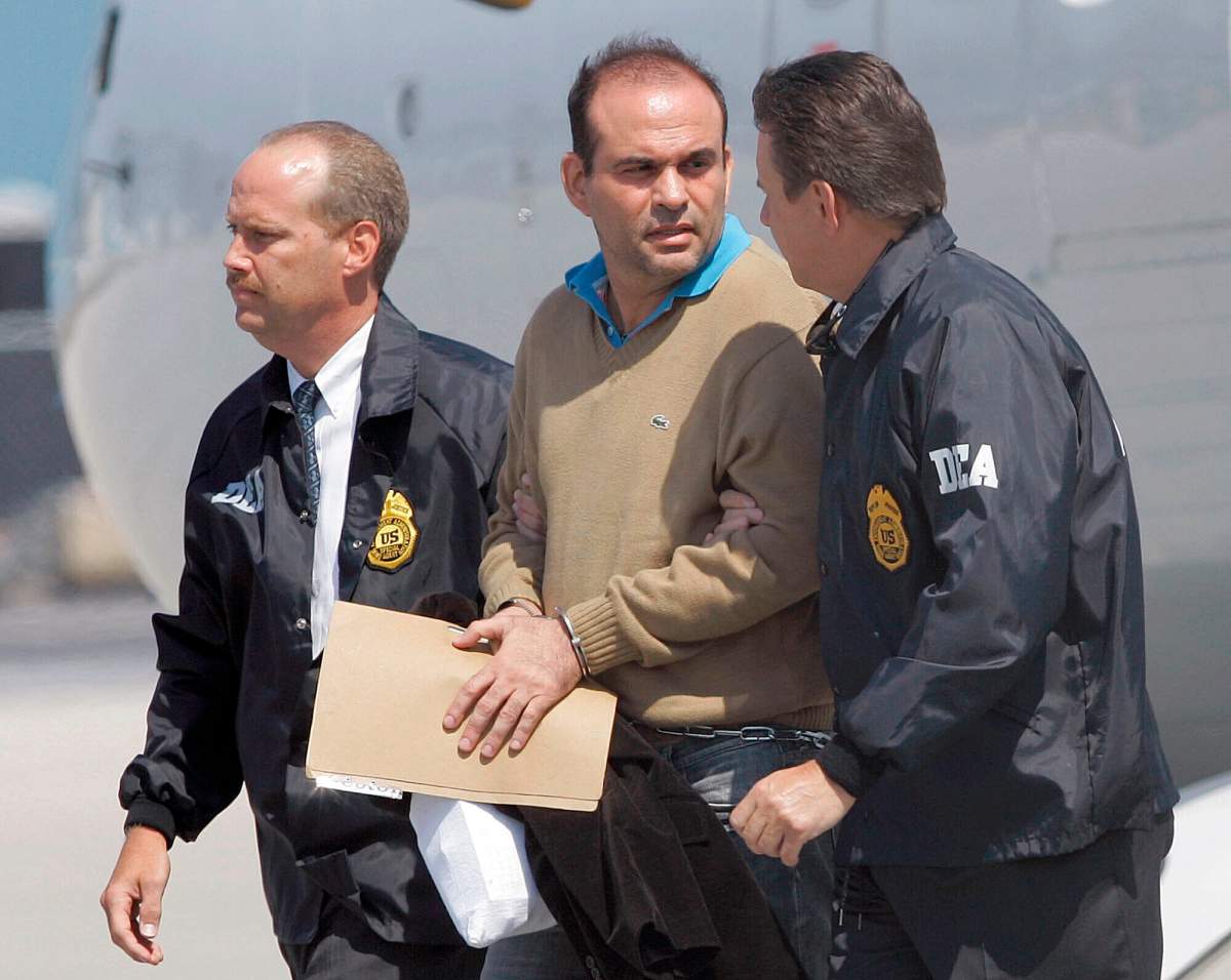 In this May 13, 2008 file photo, Colombian paramilitary warlord Salvatore Mancuso is escorted by U.S. DEA agents upon his arrival to Opa-locka, Florida.