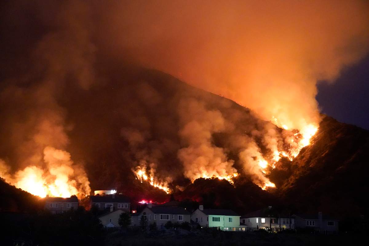 The Ranch Fire burns over a residential area, Thursday, Aug. 13, 2020, in Azusa, Calif.